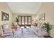 Bright living room with neutral decor, large windows, and comfortable seating arrangement at 7295 S Steele Cir, Centennial, CO 80122