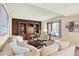 Bright living room featuring a large sofa, built-in shelving, and a cozy window seat at 7295 S Steele Cir, Centennial, CO 80122