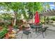 Charming patio with seating area, lush landscaping, mature trees and inviting ambiance at 7295 S Steele Cir, Centennial, CO 80122