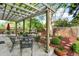 Inviting outdoor patio area with a pergola, stylish furniture, and beautiful landscaping at 7295 S Steele Cir, Centennial, CO 80122