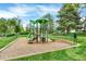 Community playground with climbing structure, slides, and surrounding green space for recreational activities at 7295 S Steele Cir, Centennial, CO 80122