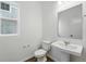 Clean, well-lit half-bathroom with a pedestal sink and modern fixtures at 7279 Prairie Sage Pl, Littleton, CO 80125