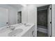 Bathroom features double sink vanity, large mirror and tiled shower at 7279 Prairie Sage Pl, Littleton, CO 80125