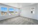 This carpeted bedroom has large windows that provide lots of natural light at 7279 Prairie Sage Pl, Littleton, CO 80125