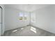 Neutral bedroom featuring carpet, three bright windows, and white walls at 7279 Prairie Sage Pl, Littleton, CO 80125