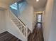 Bright entryway with hardwood floors and a staircase leading to the second floor at 7279 Prairie Sage Pl, Littleton, CO 80125