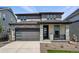 Modern two-story home featuring stone accents, a gray color scheme, and a two-car garage at 7279 Prairie Sage Pl, Littleton, CO 80125
