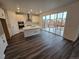 Modern kitchen with white cabinetry, stainless steel appliances, and a large island with hardwood floor at 7279 Prairie Sage Pl, Littleton, CO 80125