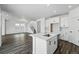 This kitchen features white cabinets, stainless steel appliances, granite countertops, and flows into the living room at 7279 Prairie Sage Pl, Littleton, CO 80125