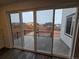 Sliding glass doors opening to a large patio with views of the neighborhood at 7279 Prairie Sage Pl, Littleton, CO 80125