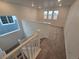 Carpeted stairway with white railing leading to the upper level of the home at 7279 Prairie Sage Pl, Littleton, CO 80125
