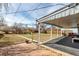 Spacious backyard featuring a covered patio, lush lawn, and a charming wooden playset at 3041 S Glencoe St, Denver, CO 80222