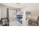 A bedroom with a bunkbed, desk, and soft, natural lighting at 3041 S Glencoe St, Denver, CO 80222