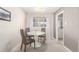 Bright dining area with modern table, chairs, and a window for natural light at 3041 S Glencoe St, Denver, CO 80222