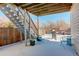 Snowy backyard with patio furniture and grill at 11822 Meadowood Ln, Parker, CO 80138