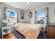 Cozy bedroom with natural light from two windows and unique decor at 1730 W 51St Ave, Denver, CO 80221