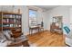 Bedroom featuring hardwood floors, large window, unique decor, and a cozy reading nook at 1730 W 51St Ave, Denver, CO 80221
