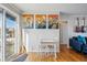Cozy dining area with sliding glass doors and stylish cactus-themed artwork at 1730 W 51St Ave, Denver, CO 80221