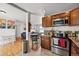 Charming kitchen featuring wooden cabinets, stainless steel appliances and a view to the living room at 1730 W 51St Ave, Denver, CO 80221