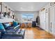 Bright living room features hardwood floors, natural light, and decorative guitar displays at 1730 W 51St Ave, Denver, CO 80221