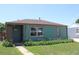 Charming single-story home features a well-maintained lawn and beautiful flower beds along the front of the house at 1730 W 51St Ave, Denver, CO 80221