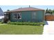 Single-story home with well-maintained lawn and flower beds; driveway to the right at 1730 W 51St Ave, Denver, CO 80221