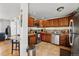 Well-lit kitchen features stainless steel appliances, granite counters, and beautiful wood cabinetry at 1730 W 51St Ave, Denver, CO 80221