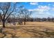 Neighborhood park with playground and mature trees offers beautiful city views in the background at 1730 W 51St Ave, Denver, CO 80221