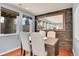 Dining room with hardwood floors, wood-paneled accent wall, and large mirror at 3560 N Adams St, Denver, CO 80205