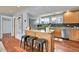 Modern kitchen with island, stainless steel appliances, and hardwood floors at 3560 N Adams St, Denver, CO 80205