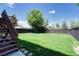 Beautifully landscaped backyard with lush green grass and a wooden privacy fence offers ample space at 3689 Primrose Ln, Castle Rock, CO 80109