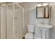 Bathroom with a walk-in shower, pedestal sink and wood-look vinyl flooring at 3689 Primrose Ln, Castle Rock, CO 80109