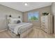 Bright bedroom with large window and light wood dresser at 3689 Primrose Ln, Castle Rock, CO 80109