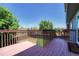 Cozy outdoor deck with wooden railing overlooks a well-maintained backyard and blue skies at 3689 Primrose Ln, Castle Rock, CO 80109