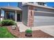 Inviting front entrance of the two-story home, featuring a gray exterior and a well-manicured garden at 3689 Primrose Ln, Castle Rock, CO 80109
