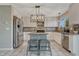 Bright kitchen features granite counters, stainless appliances and an island with seating at 3689 Primrose Ln, Castle Rock, CO 80109