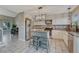 Bright kitchen features granite counters, stainless appliances and an island with seating at 3689 Primrose Ln, Castle Rock, CO 80109