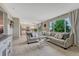 Bright living room with large windows and view into kitchen and dining at 3689 Primrose Ln, Castle Rock, CO 80109