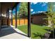 Green backyard featuring artificial turf and modern wood fence, with a view of the home's exterior at 21 Washington Ave, Golden, CO 80403