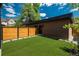 Well-maintained backyard with artificial turf, wood fencing, and a clear view of the home's facade at 21 Washington Ave, Golden, CO 80403
