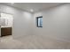 Bright bedroom with a window and neutral carpet, leading to an ensuite bathroom with modern fixtures at 21 Washington Ave, Golden, CO 80403