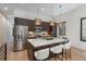 Gourmet kitchen featuring modern pendant lights, white countertop island, and stainless steel appliances at 21 Washington Ave, Golden, CO 80403