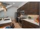 Gourmet kitchen featuring modern appliances, dark wood cabinets, and white countertops at 21 Washington Ave, Golden, CO 80403