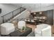 Bright living room featuring modern white furniture, wood flooring, and view into the kitchen at 21 Washington Ave, Golden, CO 80403