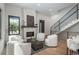 Bright living room featuring modern white furniture, wood flooring, fireplace, and lots of natural light at 21 Washington Ave, Golden, CO 80403