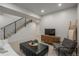 Finished living room area in the basement with stairs and television at 21 Washington Ave, Golden, CO 80403