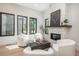 Bright living room featuring modern white furniture, wood flooring, fireplace, and lots of natural light at 21 Washington Ave, Golden, CO 80403