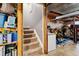 Stairs leading to the basement featuring carpeted steps and access to a recreational area at 10474 W Purgatoire Peak, Littleton, CO 80127