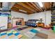 Partially finished basement with futon and tv, creating a cozy and functional living space at 10474 W Purgatoire Peak, Littleton, CO 80127