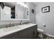 Well-lit bathroom with a double sink vanity, large mirror, and modern fixtures at 10474 W Purgatoire Peak, Littleton, CO 80127